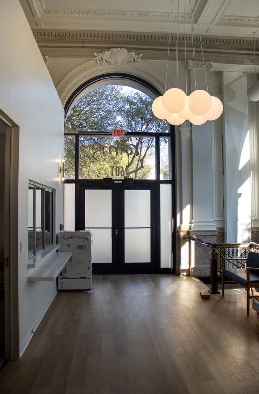 Arched window and frosted-glass entry at 601 Clement St