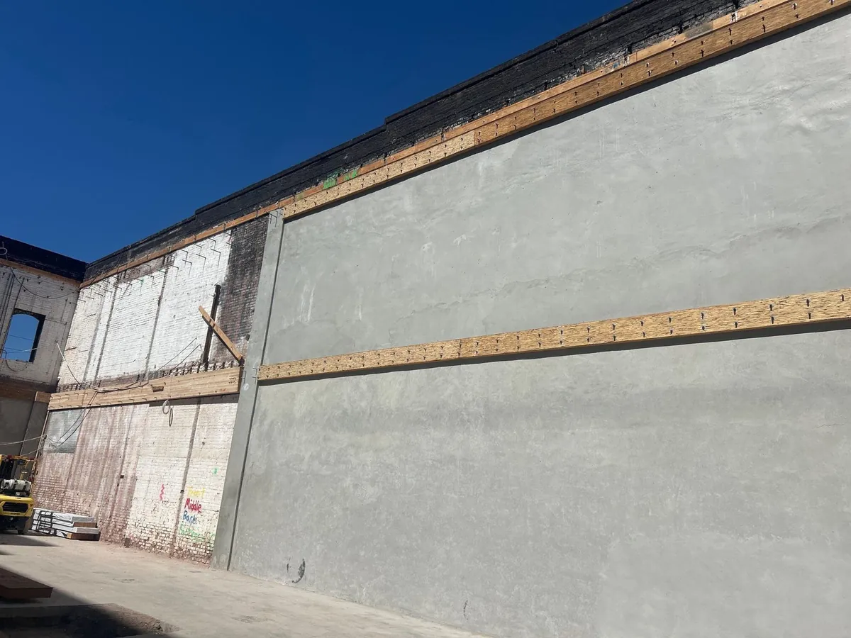 New shotcrete shear wall applied to the inside of the brick wall at 63 Bluxome St